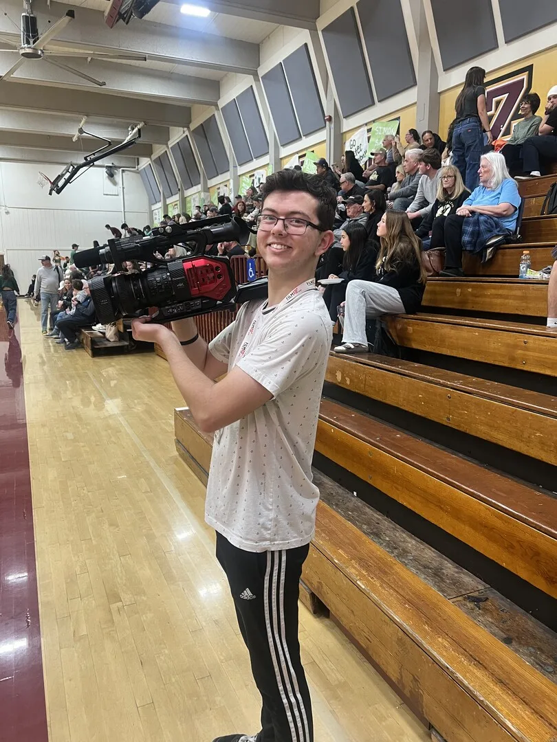 Aiden Chapman filming a varsity boys volleyball game on March 12th, 2024.